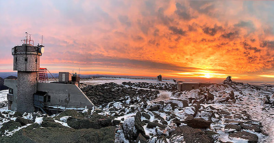 Mount Washington Observatory with a vast orange sunset